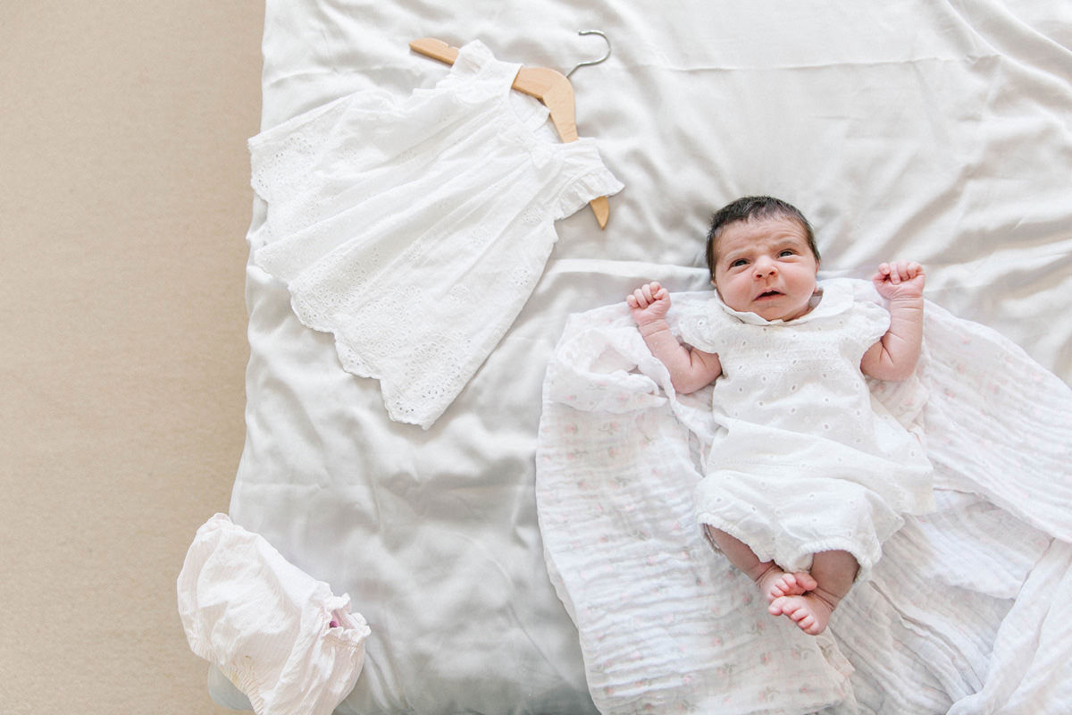 newborn baby white outfit family snuggle on the bed lifestyle photography yasmin anne