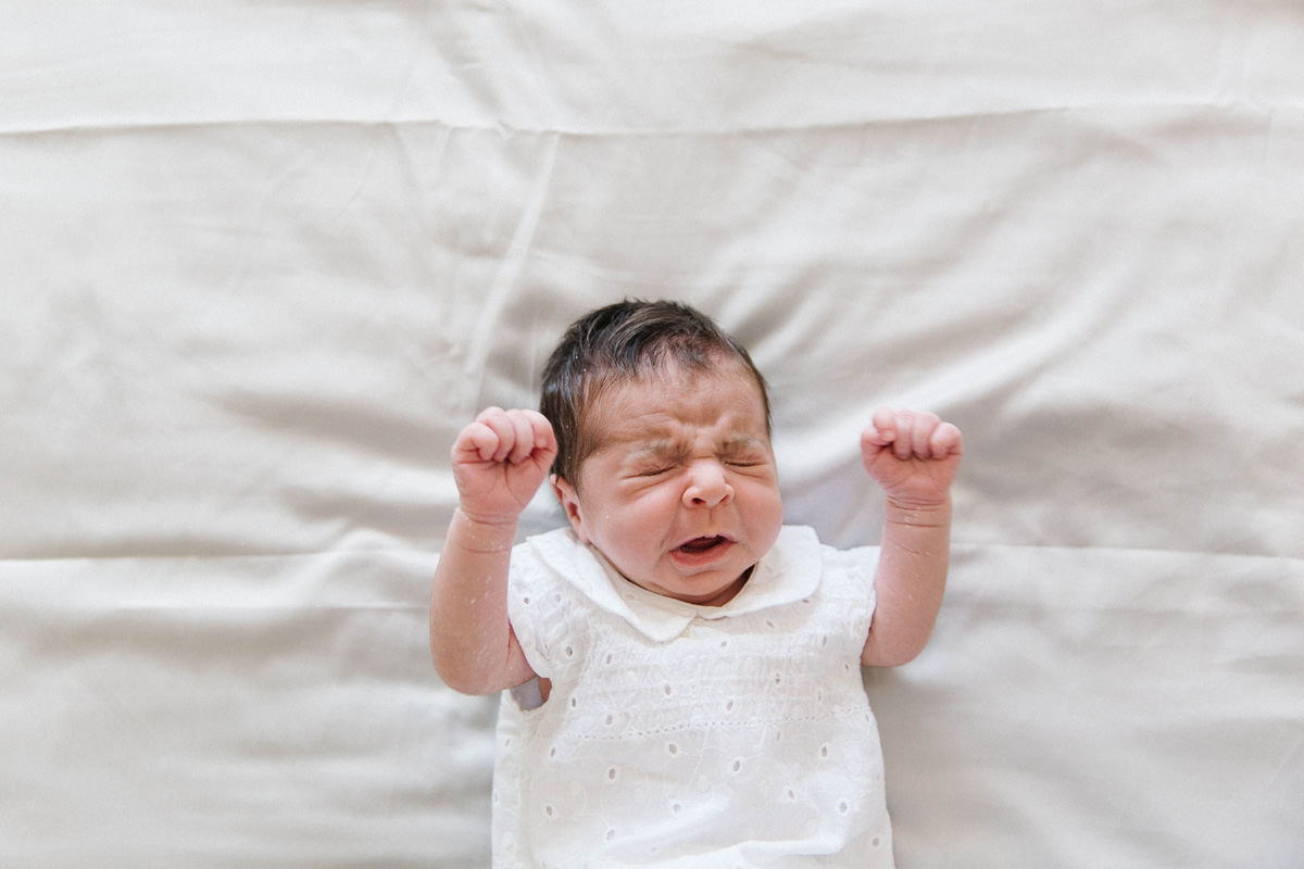 newborn girl white outit sneeze family snuggle on the bed lifestyle photography yasmin anne