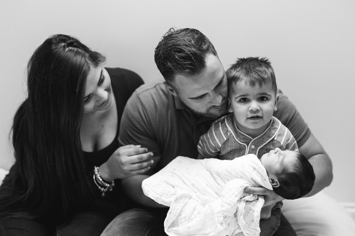 close up black and white family snuggle on the bed lifestyle photography yasmin anne