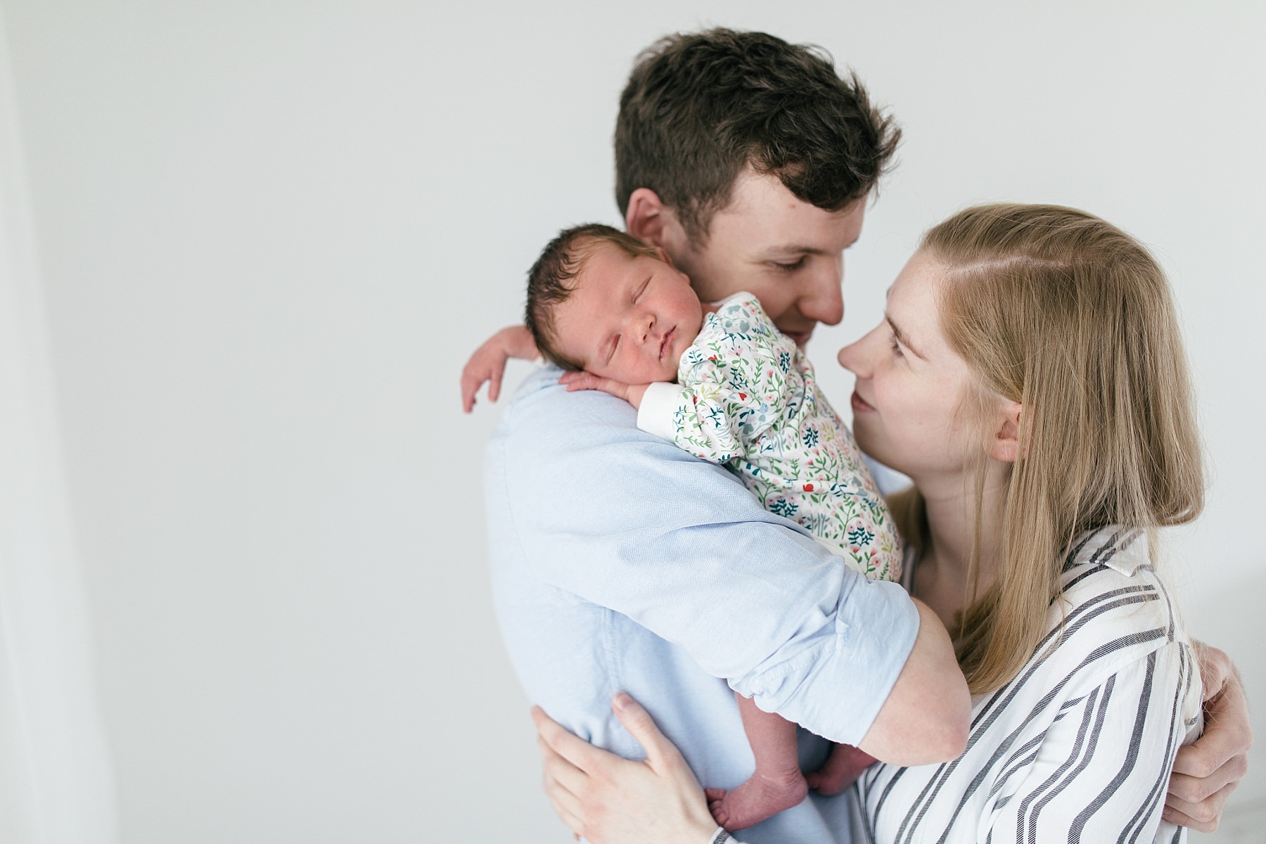 mum and dad holding newborn baby spring photo studio photography