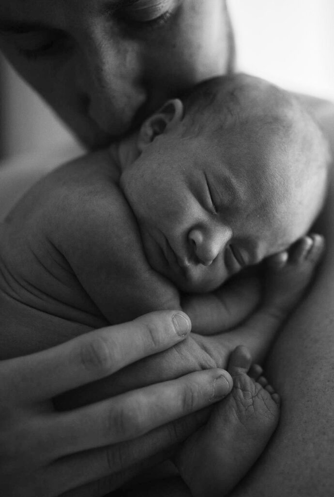 Father holds newborn baby 