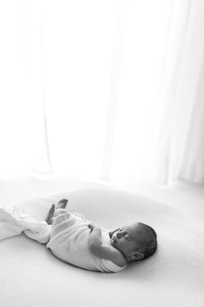 Newborn baby lying on beanbag asleep