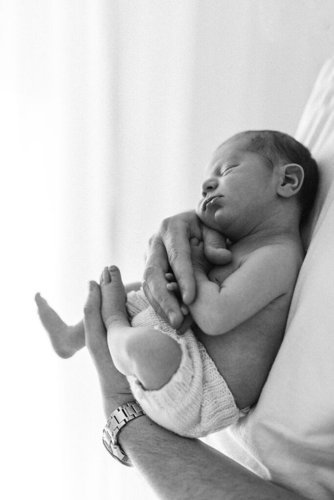 Dad holding newborn baby