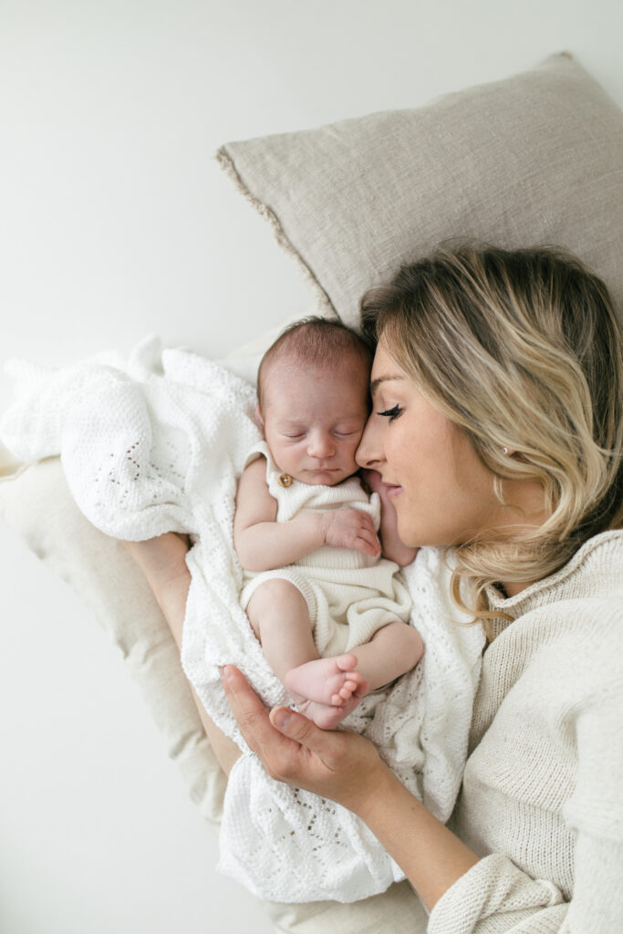 Photograph of mother and baby lying together 