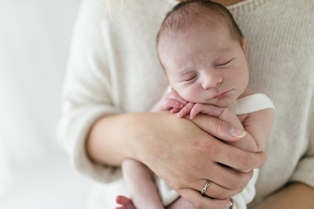 Mother holds newborn baby 