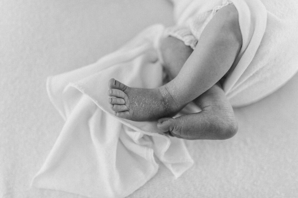 Close up of baby's feet in black and white