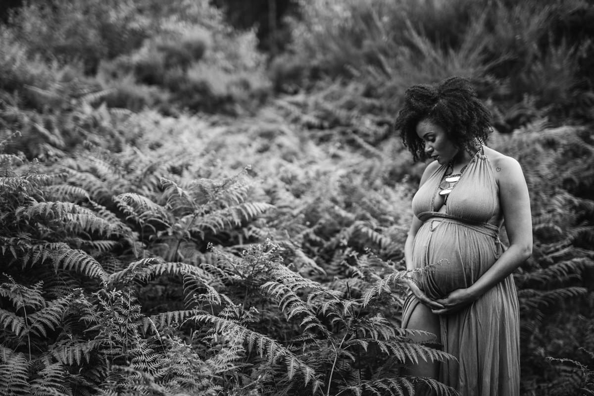 black and white shot of pregnant mum outdoors in ferns Maternity pregnancy bump image natural white studio eversley hampshire. berkshire and surrey yasmin anne photography