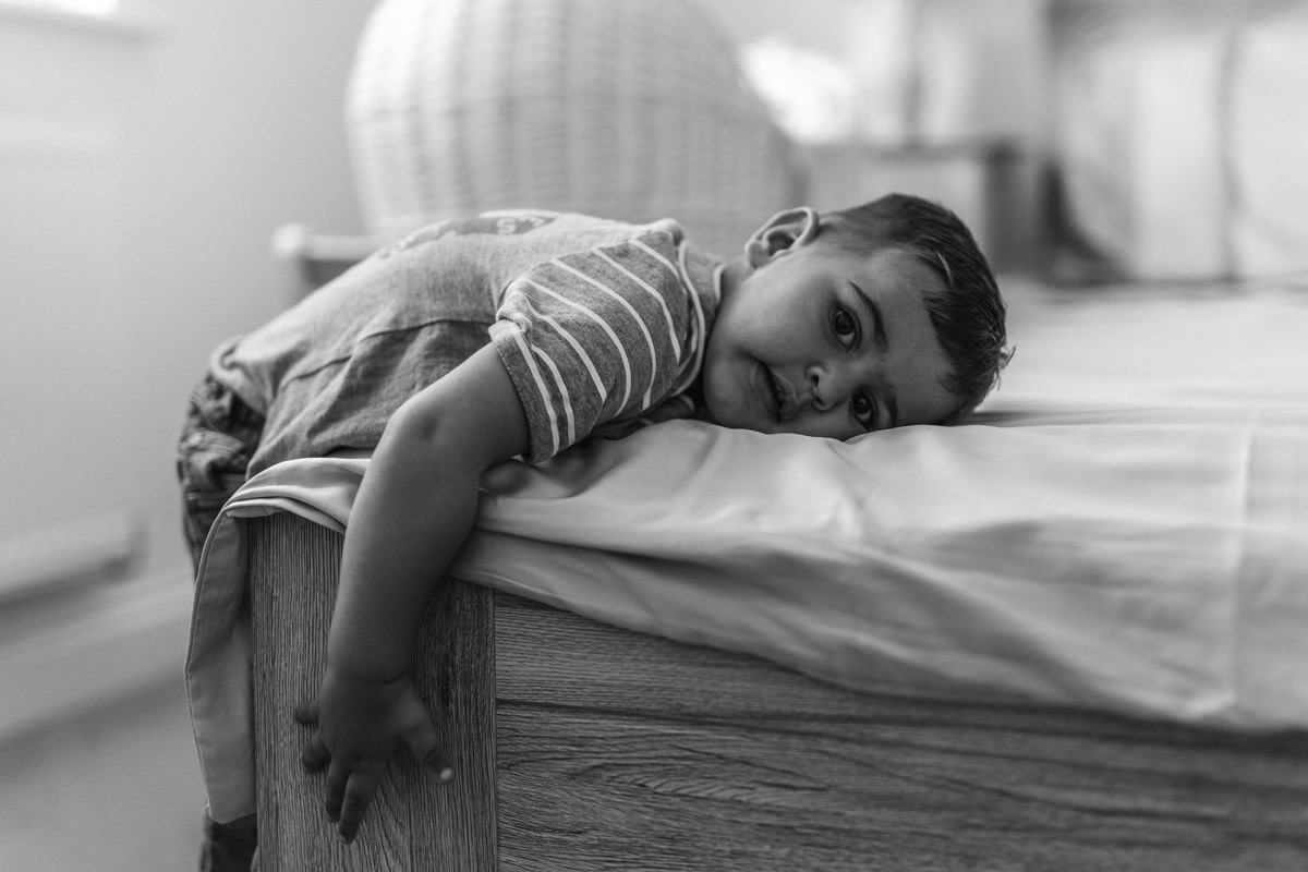 black and white toddler family snuggle on the bed lifestyle photography yasmin anne