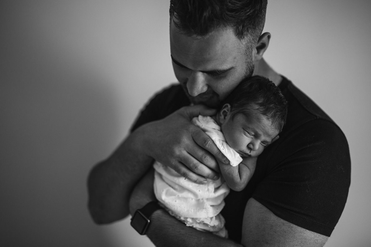 daddy and daughter black and white family snuggle on the bed lifestyle photography yasmin anne