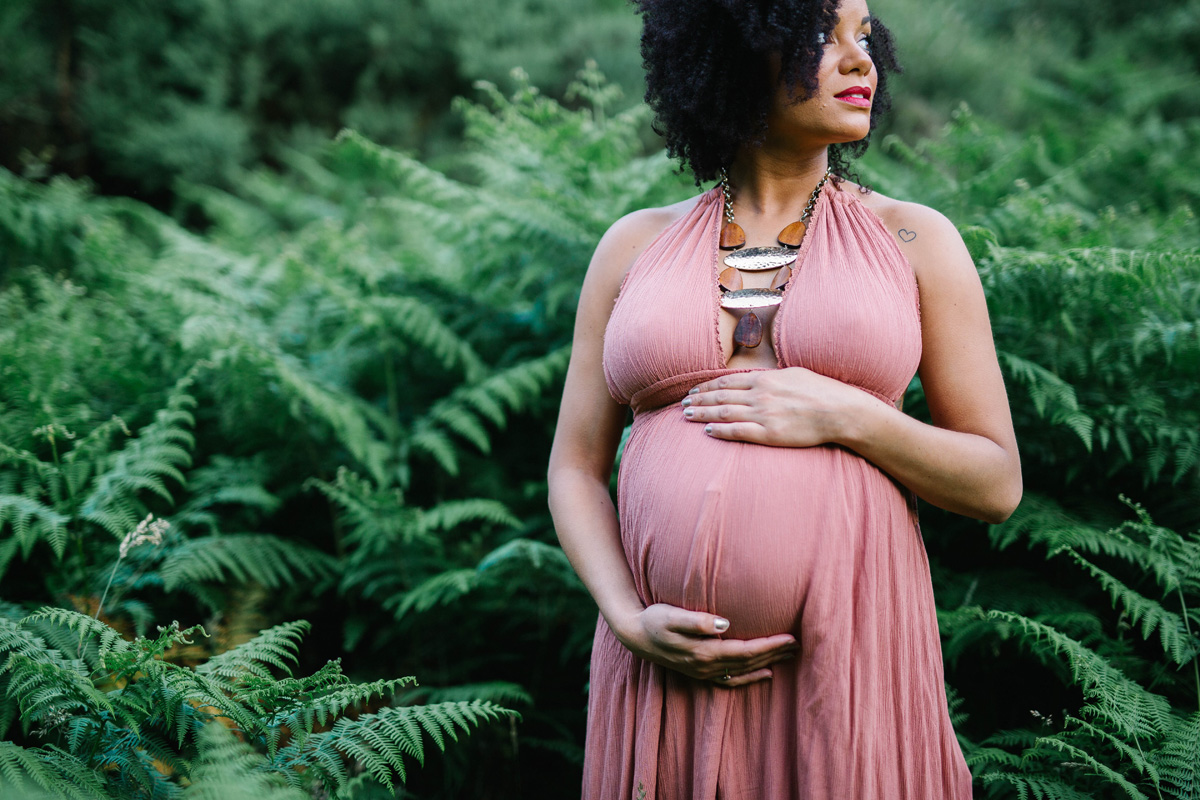outdoor maternity in free people dress afro hair in ferns Maternity pregnancy bump image natural hampshire berkshire surrey yasmin anne photography