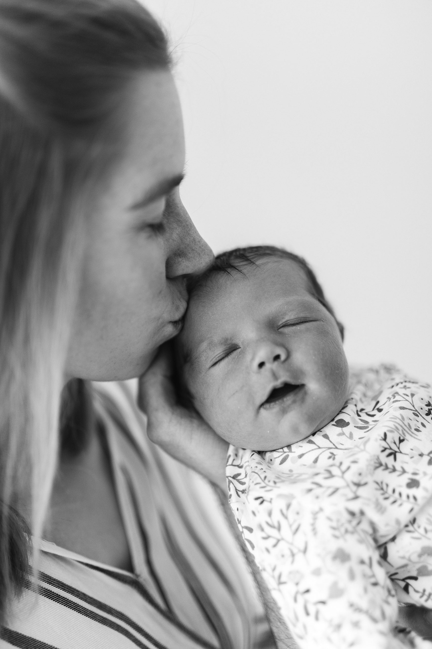 mum holding kiss newborn baby spring photo studio photography